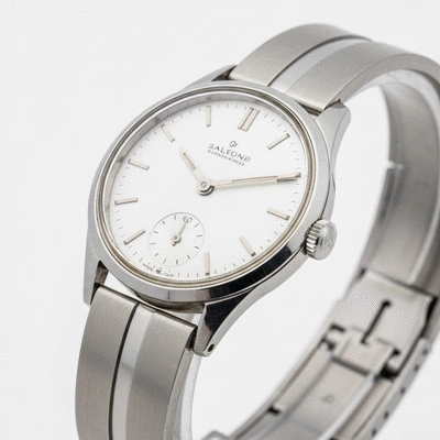 Close-up of a mid-century modern vintage watch with a minimalist design, stainless steel case, and simple dial on a clean background