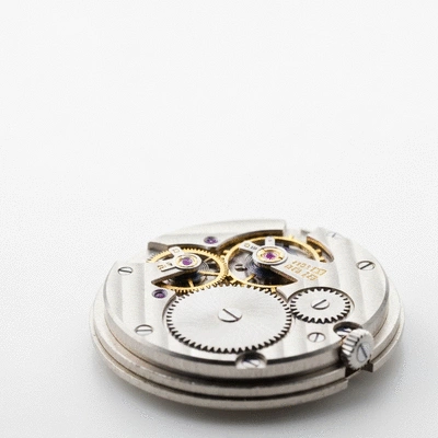 Close-up of intricate mechanical watch movement with gears and springs visible