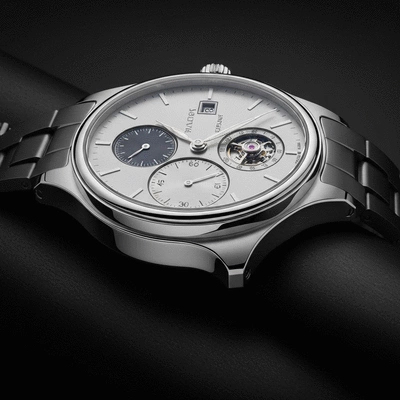 Close-up of a meticulously crafted luxury watch on a dark, elegant surface