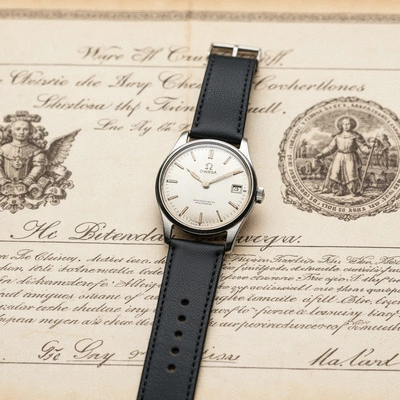 Omega vintage watch on a historical document, symbolizing milestones