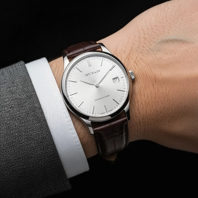Close-up of a man's wrist wearing a luxurious classic watch, with a subtle background of a finely tailored suit sleeve