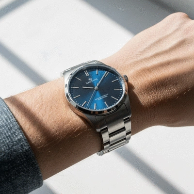 Close-up of a stylish men's wristwatch on a wrist, showcasing its design and craftsmanship