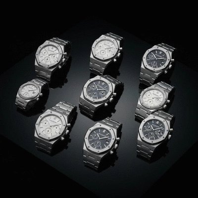 A collection of luxury Audemars Piguet watches displayed elegantly on a dark, polished surface, showcasing their design and craftsmanship