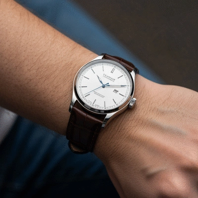 Close-up of a classic luxury watch on a wrist with blurred background